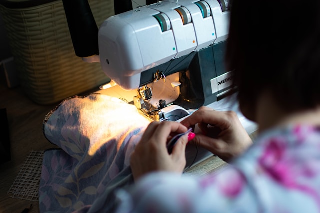 Tailor working on custom clothing alterations, illustrating how personalized training is crafted to fit individual needs and goals.